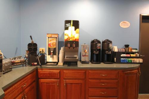a kitchen counter top with a coffee maker on it at Baymont by Wyndham Lafayette - Purdue University in Lafayette