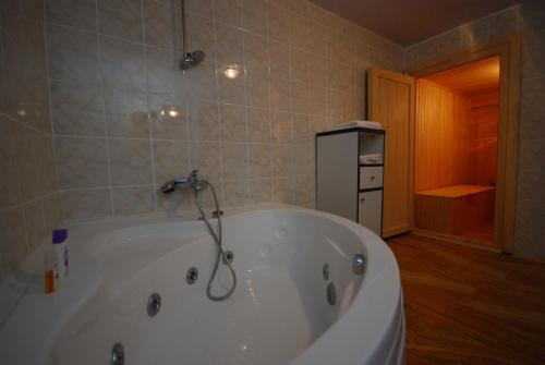 a large white bath tub in a bathroom at Karamanli Konagi in Guzelyurt