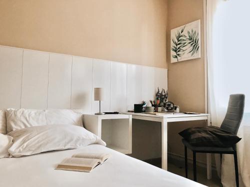 a bedroom with a bed with a desk and a chair at Metropolitan Atocha in Madrid