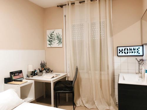 a bedroom with a desk and a bed with a laptop at Metropolitan Atocha in Madrid