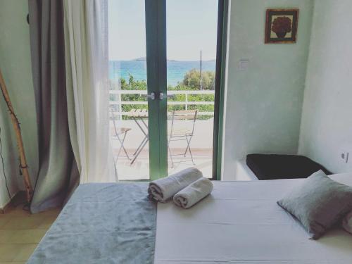 a bedroom with a bed and a view of the ocean at Filio Guesthouse in Kipri