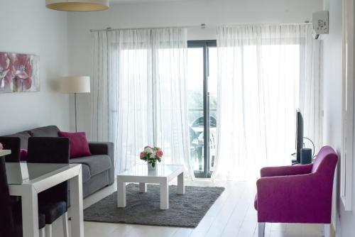 a living room with a couch and a table at Albur Village in Alvor