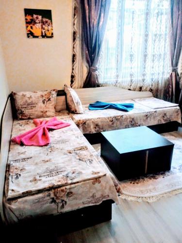 a room with two beds and a table in it at Rose & Water Guest house in Pavel Banya