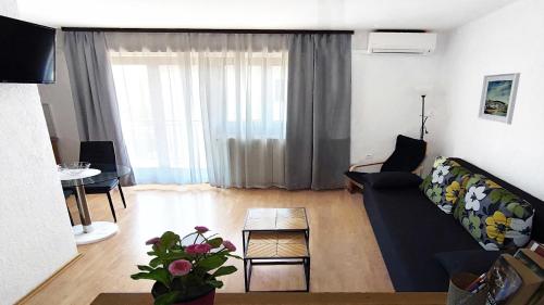 ein Wohnzimmer mit einem Sofa und einem Tisch in der Unterkunft Amélie Apartments in Poreč