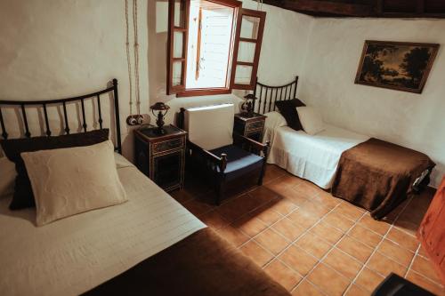 سرير أو أسرّة في غرفة في Villa Los Hinojales