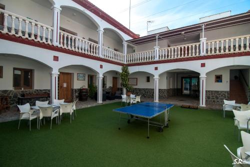 a ping pong table in the courtyard of a building at Camping las Catalinas in Ríolobos