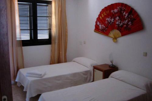 ein kleines Zimmer mit 2 Betten und einem Fenster in der Unterkunft Casa Rosita in Agaete
