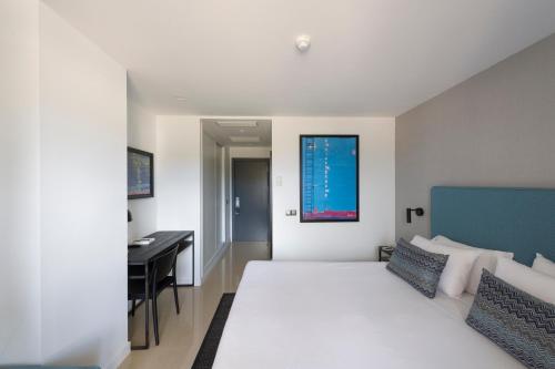 Ένα ή περισσότερα κρεβάτια σε δωμάτιο στο Hotel Tahiti