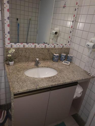 a bathroom counter with a sink and a mirror at Beach Class Muro Alto Porto de Galinhas in Porto De Galinhas
