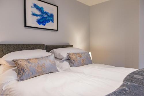 a bedroom with two white pillows on a bed at Customs House by Bloom Stays in Faversham