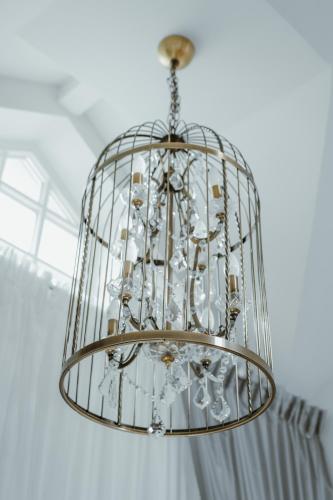 a chandelier hanging from a ceiling in a room at Baltic Sea Dunes Apartments in Jūrmala