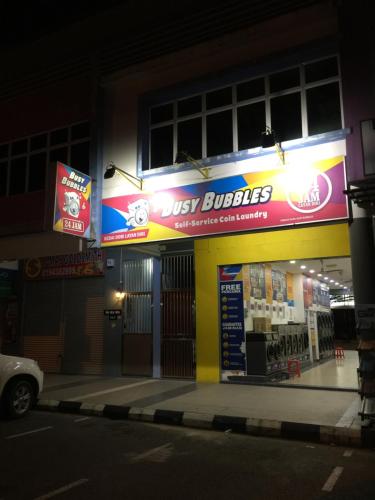 a store with a just bubbles sign on the side of a street at Tan’s Sibu jaya homestay in Rumah Ganggu