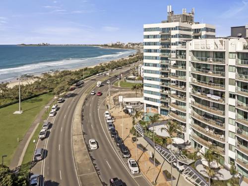 an aerial view of a road next to a beach at Key Largo Maroochydore in Maroochydore