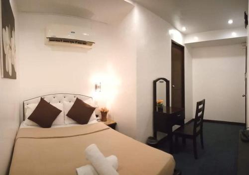 Postel nebo postele na pokoji v ubytování Amax Inn Cebu