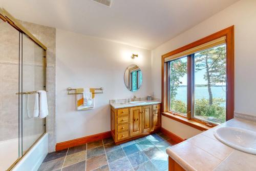 a bathroom with a sink and a window at Fanta Sea Shores in Wiscasset