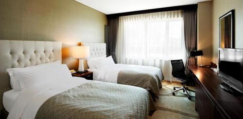 Ένα ή περισσότερα κρεβάτια σε δωμάτιο στο Nongshim Hotel