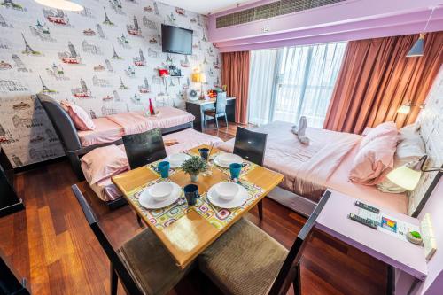 a room with a table and a bed and a dining room at Resort Suites Pyramid & Lagoon in Petaling Jaya