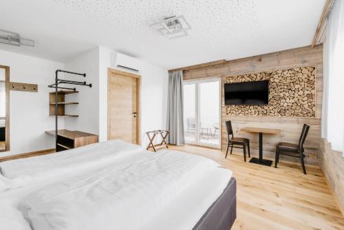a bedroom with a bed and a table with chairs at Jacky's Mühle in Gols