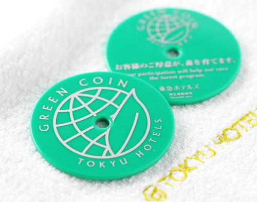 two green tags on a white towel with at Kanazawa Tokyu Hotel in Kanazawa