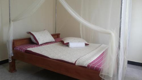 Tempat tidur dalam kamar di Jojo's Palace Annex