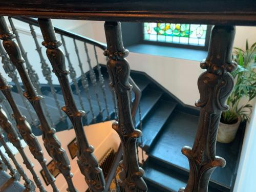 a spiral staircase with a view of a window at 23 Mayfield in Edinburgh