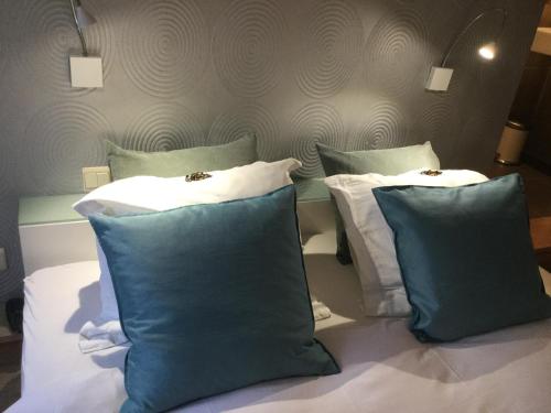two pillows sitting on a bed in a room at B&B Hip in Bruges