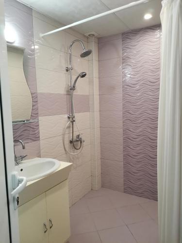 a bathroom with a shower and a sink at Primorski Briz Guest House in Primorsko