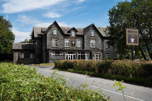 an old house with a sign in front of it at The Coniston Inn - The Inn Collection Group in Coniston