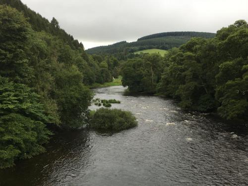 a river with trees on the sides of it at Yairbrig Holiday in Galashiels