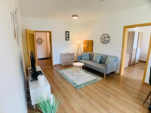 a living room with a couch and a table at Komfortables Apartment in Bad Elster mit Netflix in Bad Elster