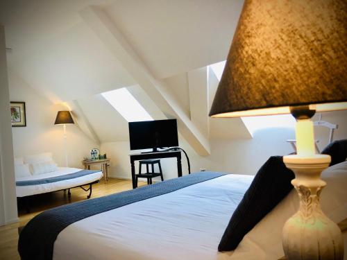 Postel nebo postele na pokoji v ubytování L’Auberge de Mézières