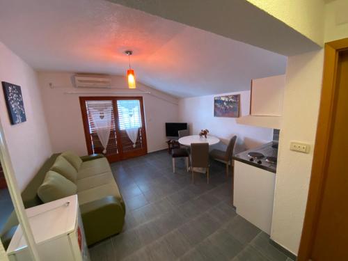 a living room with a couch and a table and a kitchen at Misho Apartments in Kruševo