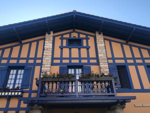 a blue and yellow building with a balcony at Suites Mendibil Irun in Irún