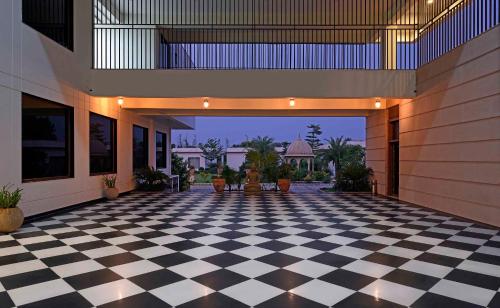 a lobby with a black and white checkered floor at Clarks Safari Ranthambore in Khilchipur