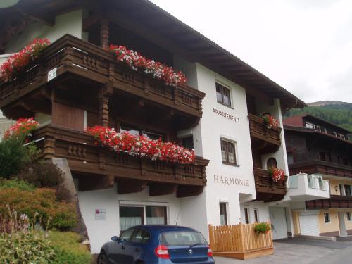 a building with flowers on the balconies of it at Appartement Harmonie in Sölden