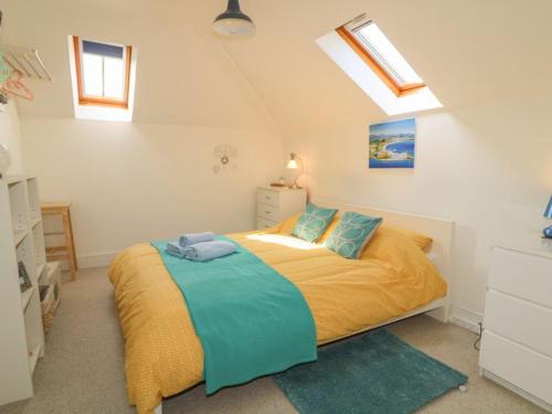 a bedroom with a large bed with blue pillows at Shell Hill Mews in Coleraine