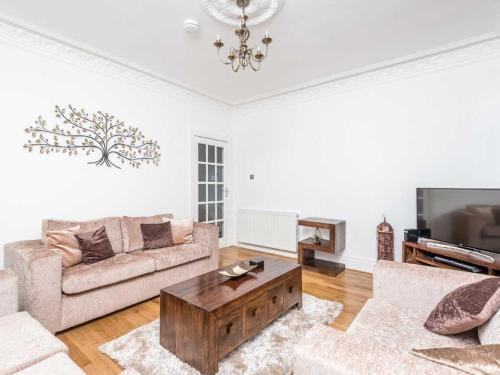 a living room with a couch and a coffee table at Casa Fresa - Ferry House in Broughty Ferry