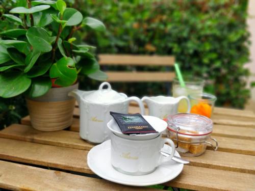 a table with a cup of tea and a book on it at Hotel Astoria Gent in Ghent