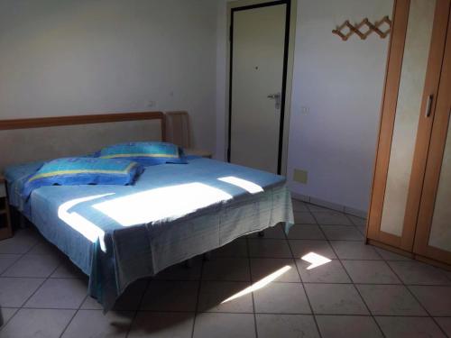 una camera da letto con un letto con cuscini blu di Residence ONDA BLU 2 a Cervia