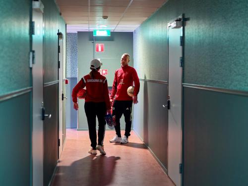 a man and a woman walking down a hallway at Göteborg Hostel in Gothenburg