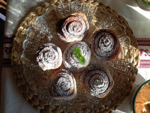 a plate of cakes with powdered sugar on it at Csodaszarvas Vendégházak in Rábahidvég