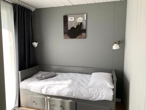 a small bed in a room with at HARMONY Design and Vacation House in Bigauņciems