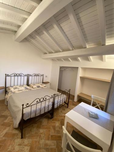 a bedroom with a bed and a table at B&B Marina in Fosdinovo