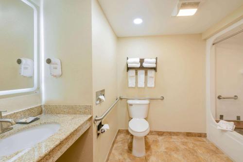 a bathroom with a toilet and a sink at La Quinta by Wyndham Columbus - Grove City in Grove City