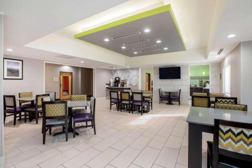 a waiting room with tables and chairs in a hospital at La Quinta Inn by Wyndham Livermore in Livermore