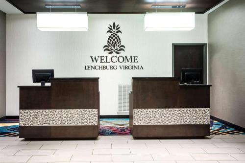 a welcome sign on a wall in a lobby at La Quinta by Wyndham Lynchburg at Liberty Univ. in Lynchburg