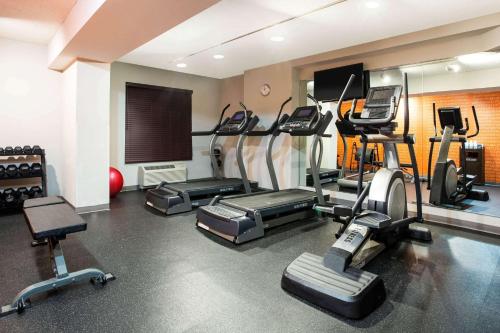 a gym with several treadmills and machines in a room at La Quinta by Wyndham Lynchburg at Liberty Univ. in Lynchburg
