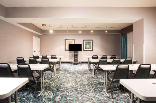 a conference room with tables and chairs and a podium at La Quinta by Wyndham Lynchburg at Liberty Univ. in Lynchburg