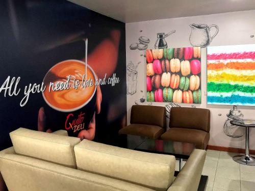 a waiting room with a couch and a painting on the wall at Swissotel Quito in Quito