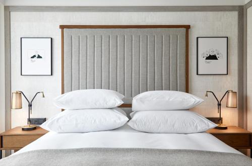 a bedroom with a bed with four pillows on it at PURO Warszawa Centrum in Warsaw